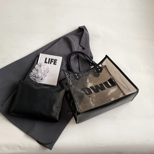 Transparent PVC tote bag with black inner pouch and OWU logo on grey background