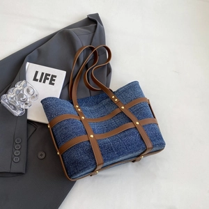 Vintage denim patchwork tote bag with brown leather straps and gold rivets for women