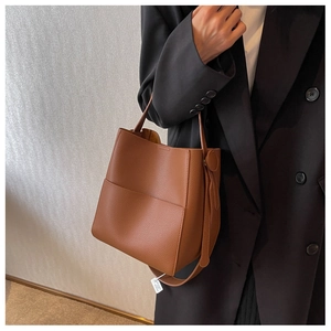 Sac seau en cuir grainé marron avec poches latérales et bandoulière réglable élégante