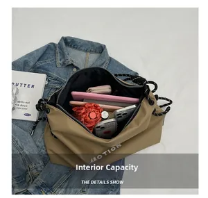 Detail showing internal capacity of the khaki nylon tote bag with daily essentials