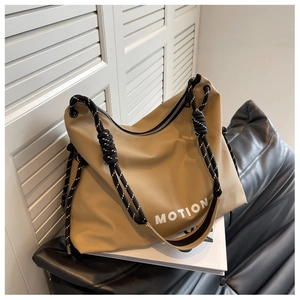 Detail of light khaki nylon tote bag with MOTION print and black and white rope strap