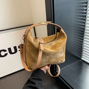 Minimalist mustard yellow velvet crossbody bag with brown leather handle and gold hardware