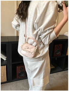 Sweet pink mini crossbody bag with delicate white lace trim and metal bow detail