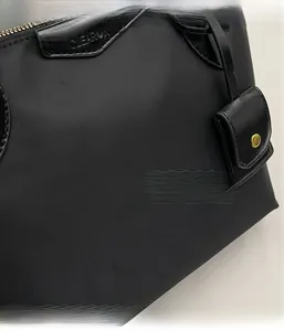 Detail shot of the black Oxford tote bag showing fabric texture and gold metal zipper
