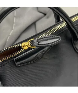 Detail of premium black oxford cloth bag with polished gold zipper and leather puller