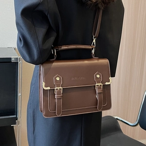 Brown leather vintage messenger bag with top handle and adjustable shoulder strap
