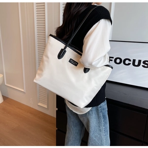 Minimalistische cremefarbene Oxford-Einkaufstasche mit schwarzen Kontrasten im Studio-Look