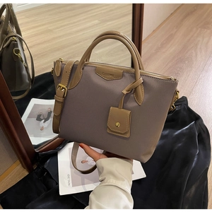 Detail view of large Oxford cloth tote with leather straps and CLEAROK brand name tag