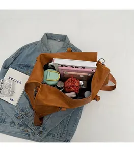 Macro shot of large capacity travel bag interior showing tablet and daily essentials