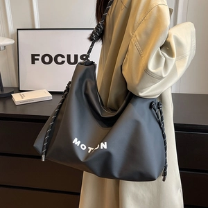 Large capacity black nylon tote bag with MOTION print and white rope shoulder strap