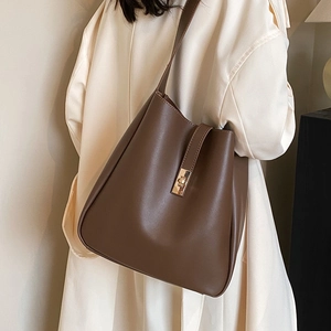 Deep brown minimalist leather bucket bag with gold lock for daily commuter style