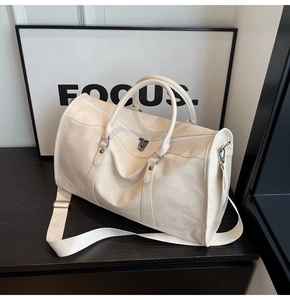 Close-up of litchi texture leather travel bag with durable handles and adjustable strap