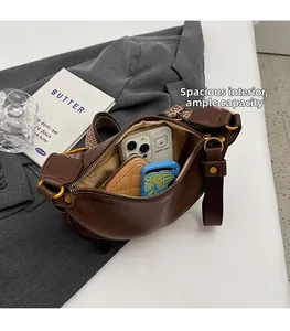 Deep brown crescent bag interior view showing large storage capacity for phone and wallet
