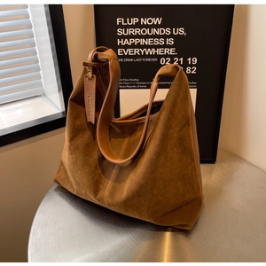 Detail view of large caramel suede tote bag with vintage matte finish and stitching