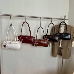 Five assorted colors of large faux leather shoulder bags with heart and pearl charms