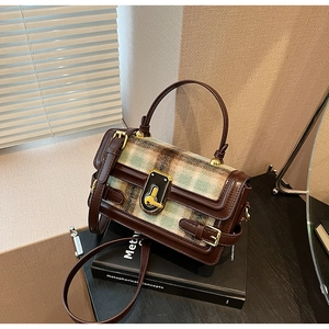 Detailed view of the vintage plaid patchwork handbag with premium leather and gold hardware