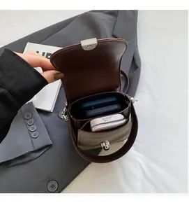 Detail view of the vintage brown crossbody bag interior with dual compartments for phones