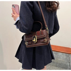 Retro plaid crossbody bag with brown leather trim and golden metal lock shown on model