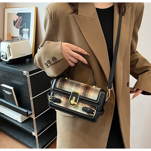 Detailed view of British vintage plaid crossbody bag with golden key lock and leather trim