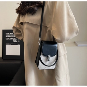 Detail of contrast stitch mini crossbody bag with silver twist lock and leather strap