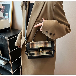 Detail of the vintage plaid flap bag showing gold hardware and dark khaki leather trim