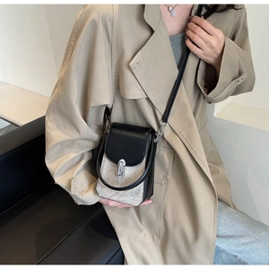 Minimalist black and grey crossbody phone bag with silver lock shown on a model
