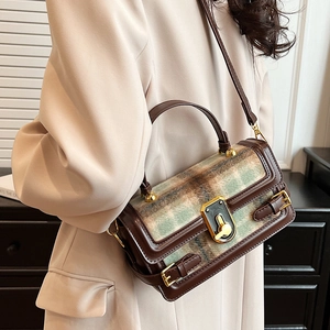 Retro green plaid shoulder bag with brown leather trim and golden twist lock closure