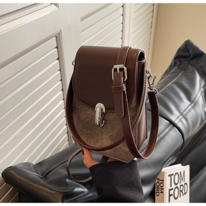 Detail of vintage patchwork crossbody phone bag with silver metal swivel lock and strap