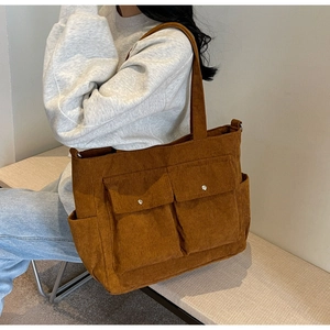 Brown corduroy tote bag detail showing multi-pocket design and soft texture for winter