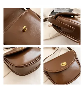 Detailed views of vintage brown saddle bag with golden metal twist lock and stitching