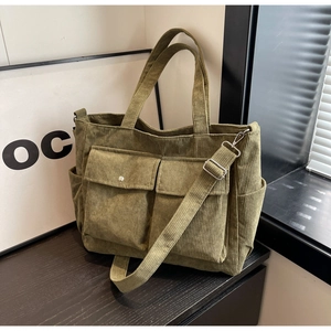 Detail view of olive green corduroy tote bag with multiple pockets and adjustable strap