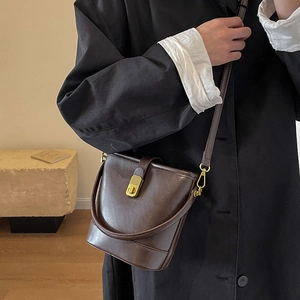 Retro dark brown leather bucket bag with gold clasp and top handle for women