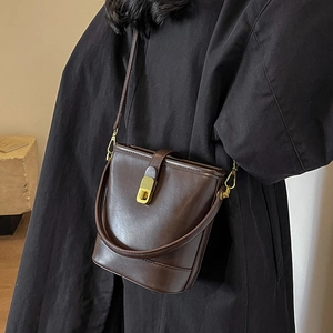 Classic dark brown bucket bag for women with gold twist lock and crossbody strap