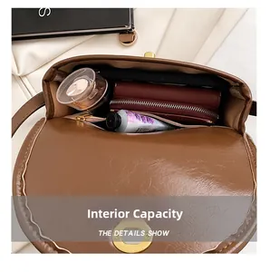 Detail shot of the internal capacity and leather texture of the brown saddle bag