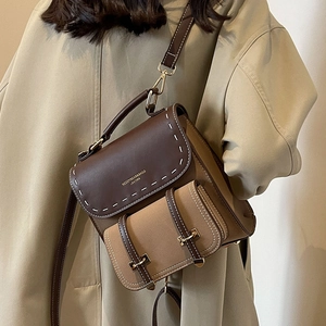 Retro two-tone leather backpack for women with vintage metal buckles and white stitching