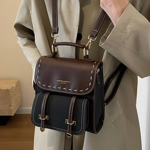 Chic retro patchwork leather backpack in black and brown with contrast stitching details