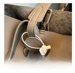 Close-up of elephant gray lychee leather with precise double-needle stitching detail
