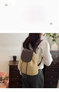 Detail of straw woven backpack with leather flap and drawstring closure for travel