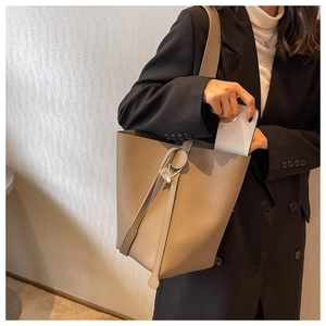 Detailed view of khaki bucket bag showing premium lychee grain leather texture and interior
