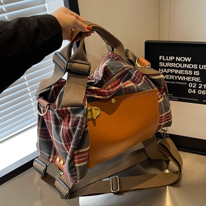 Retro plaid canvas travel handbag with brown leather accents and adjustable shoulder strap