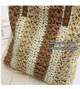 Detail of woven straw tote bag texture with brown faux leather straps and stripe pattern