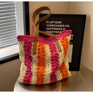 Detailansicht der gewebten Bast-Tasche mit rosa-orangefarbenen Streifen und Lederhenkeln