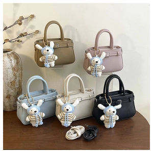 Group shot of textured leather bucket bags in five colors with cute bunny charms