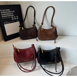 Detail view of stylish Hobo bags in four colors with decorative knotted shoulder straps
