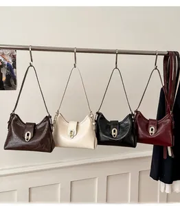 Detail view of vintage-style shoulder bags in dark brown, beige, black, and burgundy