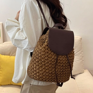 Large hand-woven straw backpack for women with brown leather straps for beach travel