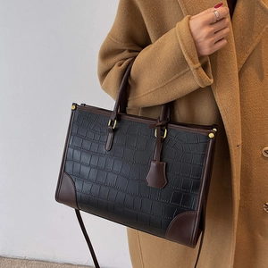 Large black crocodile pattern tote bag with brown leather trim and shoulder strap