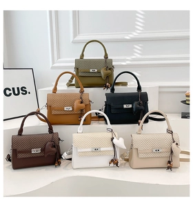 Close-up of stylish crossbody bags in six colors with woven flap and heart charm details