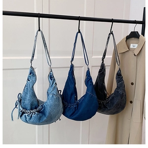 Detailed comparison of three denim crossbody bags in light blue, indigo, and dark grey