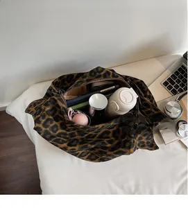 Top view of large leopard print tote bag interior showing ample storage space for daily items